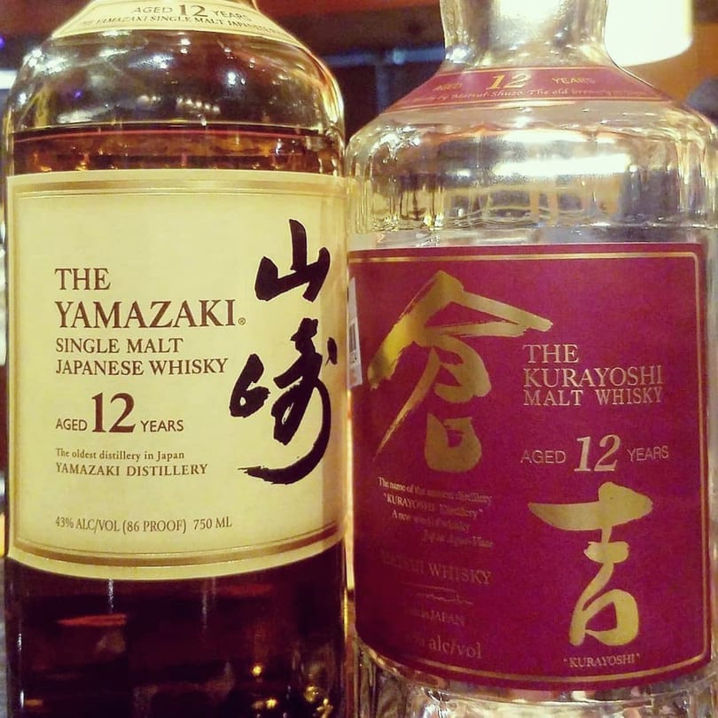 Two bottles of 12-year-old Japanese whisky, Yamazaki and Kurayoshi, on display.